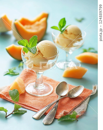 Melon ice cream in glasses. Fresh melon and mint on the table, delicious healthy dessert. 124889799