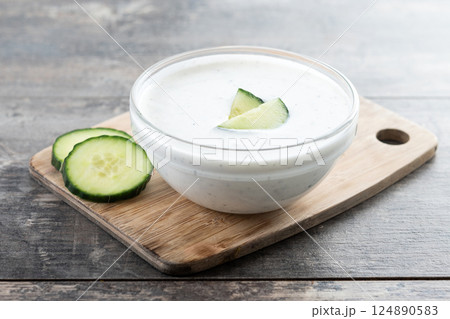 Greek Tzatziki sauce in bowl on wooden table Greek Tzatziki sauce in bowl on wooden table 124890583