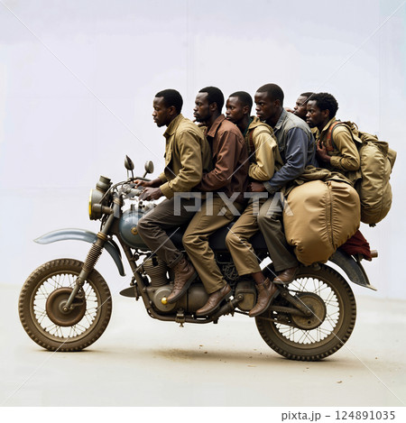 A group of men riding on the back of a motorcycle 124891035