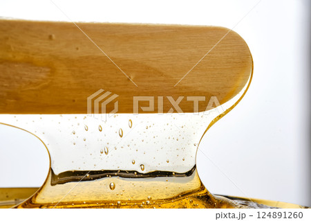 Photo of a sugar paste for depilation hair removal procedure. Texture. 124891260