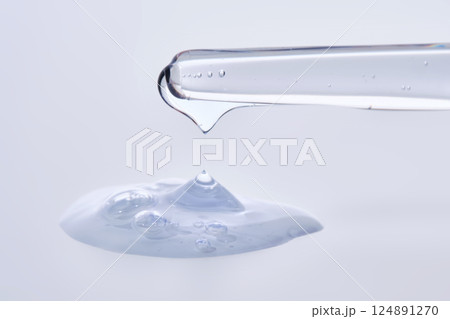 Pipette with delicate blue serum close-up. 124891270