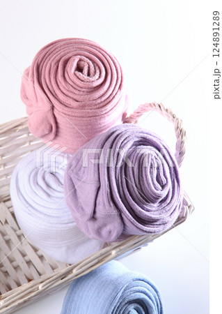 Children's tights. Colorful baby tights in basket are rolled into ball. Warm clothes for children. White background. Children's tights. Colorful baby tights in basket are rolled into ball. Warm clothes for children. White background. 124891289