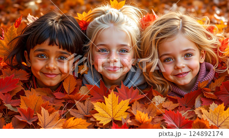 Three children in autumn leaves 124892174