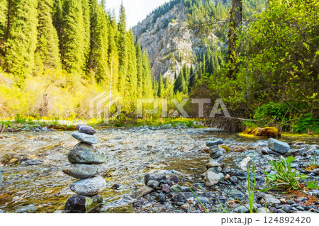pyramid of river stones on the river bank. A tower of stones in the forest pyramid of river stones on the river bank. A tower of stones in the forest 124892420