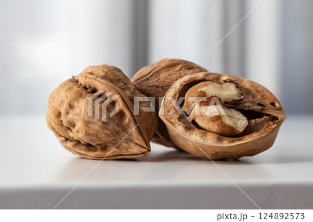 Walnut whole and half textured on a gray background front view with space for text. 124892573