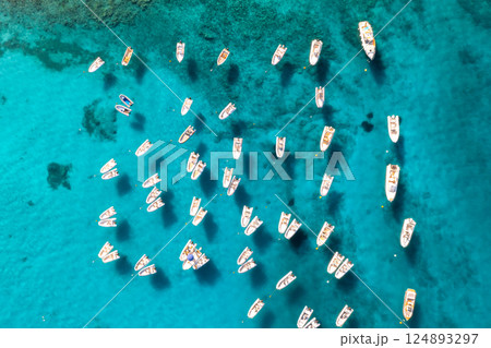 Aerial view of many motorboats on blue sea at sunset in summer 124893297