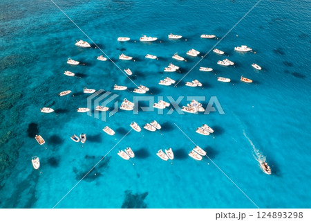 Aerial view of many motorboats on blue sea at sunset in summer Aerial view of many motorboats on blue sea at sunset in summer 124893298