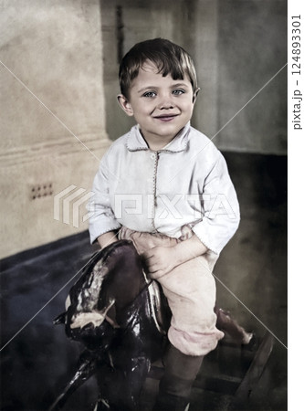 Vintage portrait of a little boy riding a wooden horse. Retro photo from 1938. 124893301