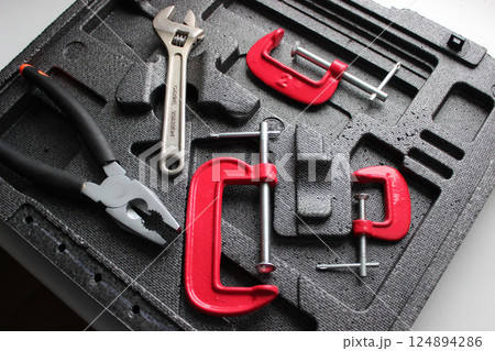 Pressure Tools Set. Engineering Equipment For Fixing And Clamping In Separate Slots Of Tool Box Pressure Tools Set. Engineering Equipment For Fixing And Clamping In Separate Slots Of Tool Box 124894286