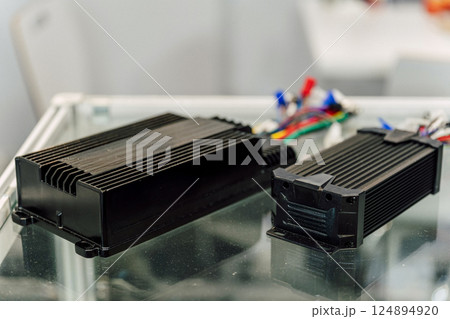 Electric motorcycle charging power supply. Portable charger for charging batteries in a scooter Electric motorcycle charging power supply. Portable charger for charging batteries in a scooter 124894920