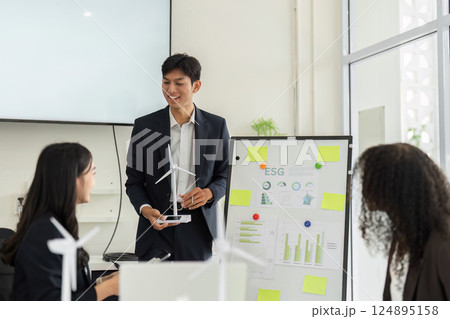 ESG Data Analysis and Team Engagement. Professionals analyzing sustainable growth metrics in an interactive meeting. 124895158