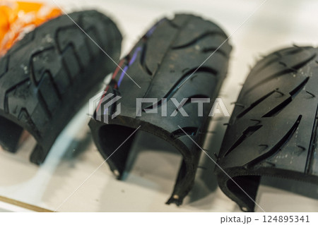 motorcycle tire in section at the exhibition. chopped tires on the counter of the fair 124895341