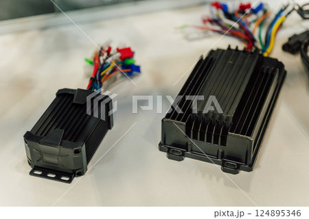 Electric motorcycle charging power supply. Portable charger for charging batteries in a scooter Electric motorcycle charging power supply. Portable charger for charging batteries in a scooter 124895346