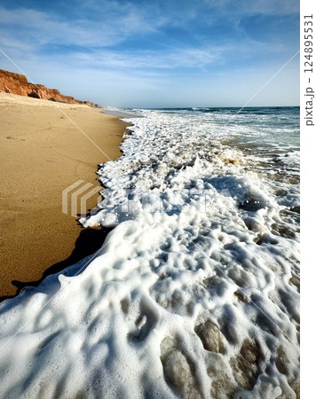 Waves on the sand at Falesia beach, Algarve, Portugal  124895531