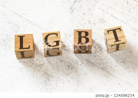 Four wooden cubes with letters LGBT (meaning lesbian, gay, bisexual, and transgender) on white working board. Four wooden cubes with letters LGBT (meaning lesbian, gay, bisexual, and transgender) on white working board. 124896254