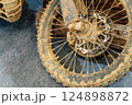 dirty off-road enduro motorcycle wheel. dirt motorcycle tire from off-road racing 124898872
