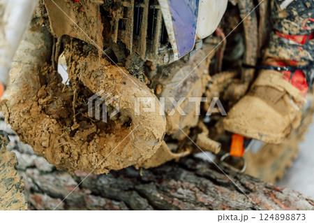 dirty muffler on a mountain bike. scooter exhaust system after mud racing 124898873