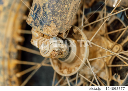 dirty off-road enduro motorcycle wheel. dirt motorcycle tire from off-road racing 124898877
