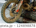 dirty off-road enduro motorcycle wheel. dirt motorcycle tire from off-road racing 124898878