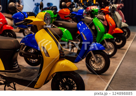 small-capacity scooters at a motorcycle exhibition. colorful scooters for the stand 124898885