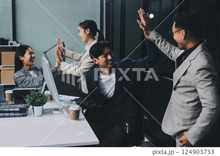 Cheerful meeting room, businesspeople celebrate with handshaking. Successful project was completed before the deadline. Business partnership and collaboration in project management. Habiliment Cheerful meeting room, businesspeople celebrate with handshaking. Successful project was completed before the deadline. Business partnership and collaboration in project management. Habiliment 124903733