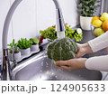 Woman hands washing fresh broccoli in the kitchen 124905633