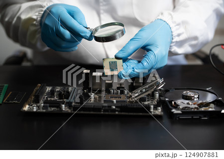 Hands repairing electronic devices. Electronic technician. 124907881