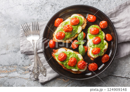 Margherita Chicken is the perfect flavour combo of basil and tomato and is topped with delicious, melty mozzarella cheese close-up. Horizontal top view 124909148