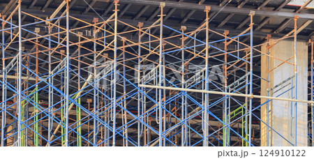 A large number of scaffoldings are used in large construction projects. Scaffolding for on construction site of the new building. A large number of scaffoldings are used in large construction projects. Scaffolding for on construction site of the new building. 124910122