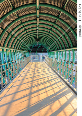 Pedestrian pathway or corridor or hallway between train station and other building. Pedestrian pathway or corridor or hallway between train station and other building. 124910124