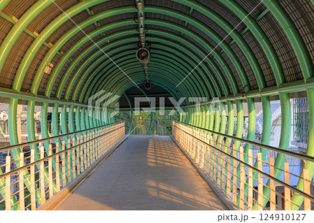 Pedestrian pathway or corridor or hallway between train station and other building. Pedestrian pathway or corridor or hallway between train station and other building. 124910127