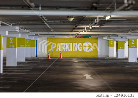 Vacant Parking Lot, dimly lit empty parking garage, parking lot with empty places, Empty Numbered parking lot waiting to be filled with vehicle Vacant Parking Lot, dimly lit empty parking garage, parking lot with empty places, Empty Numbered parking lot waiting to be filled with vehicle 124910133