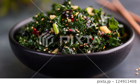 Kale salad with sesame seeds in black bowl, healthy food concept 124911408