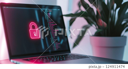 Laptop with red glowing padlock and code on screen in neon pink room 124911474