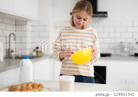 Little Girl Baking Pastries In The Kitchen, Whisking Eggs 124911545