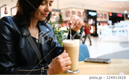 Stylish Woman Drinking Latte Coffee In A Cafe In The Trade Center 124911629