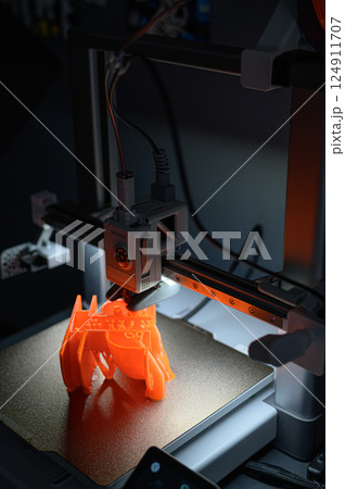 3D Printer Creating Vibrant Orange Prototype Model 3D Printer Creating Vibrant Orange Prototype Model 124911707