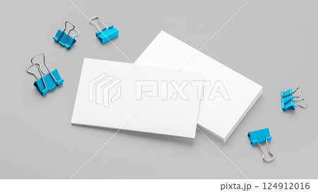Business card, mockup with blue binder clips on grey background 124912016