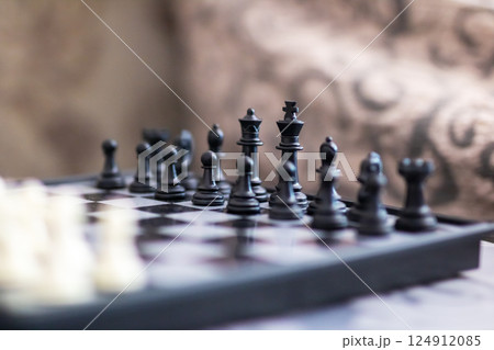 A chess board featuring both black and white pieces placed on it A chess board featuring both black and white pieces placed on it 124912085