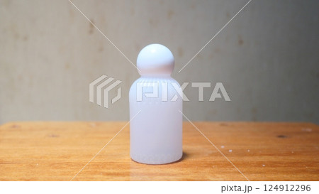 a beautifully-shaped round cap plastic bottle used for storing perfume, shampoo, or other cosmetic products a beautifully-shaped round cap plastic bottle used for storing perfume, shampoo, or other cosmetic products 124912296