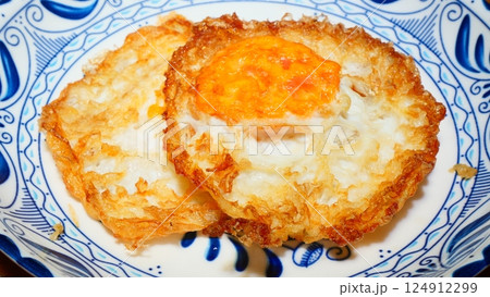 A crispy and delicious fried egg on a plate 124912299