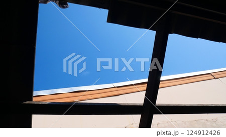 The roof of the house is being tiled The roof of the house is being tiled 124912426