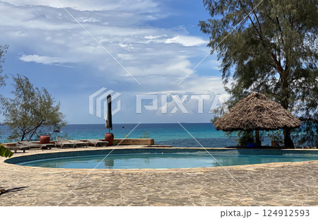 Idyllic tropical beach resort with a pool overlooking the turquoise ocean. Idyllic tropical beach resort with a pool overlooking the turquoise ocean. 124912593