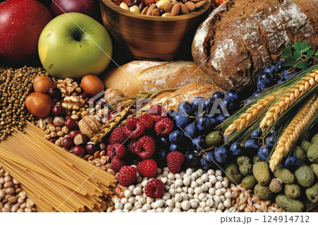 Variety of fruits and vegetables are displayed on a table, including apples 124914712