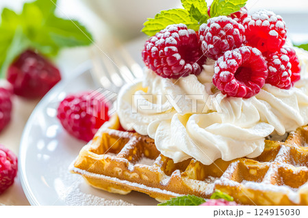 Dessert with whipped cream and raspberries on top 124915030