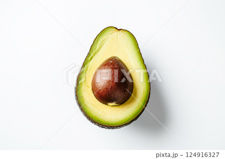 Large avocado is cut in half and placed on a white background 124916327