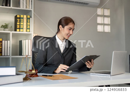 Female Attorney Analyzing Legal Documents on Clipboard Female Attorney Analyzing Legal Documents on Clipboard 124916833
