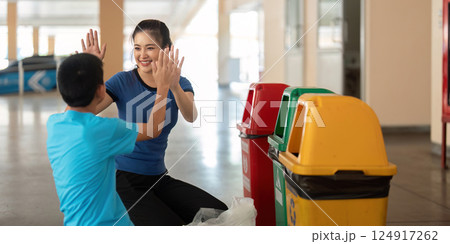 Celebration of Learning and Eco-responsibility. Child shares joy of sorting waste with a caregiver, promoting sustainability. Celebration of Learning and Eco-responsibility. Child shares joy of sorting waste with a caregiver, promoting sustainability. 124917262