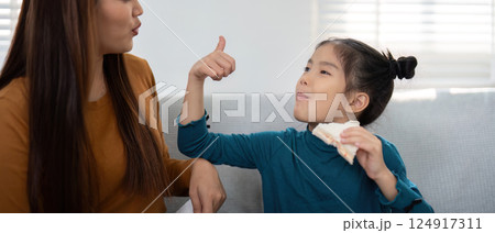 Back to School and Family Connection. Mother and daughter share a fun snack moment while preparing for school. 124917311