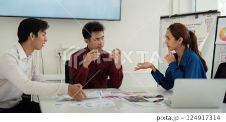 Interactive UX UI Brainstorming. Designers animatedly discuss creative ideas and approaches for effective user interface design. Interactive UX UI Brainstorming. Designers animatedly discuss creative ideas and approaches for effective user interface design. 124917314